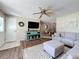 Cozy living room featuring a large sectional sofa, stylish decor, and an open layout to the dining area at 7375 Lake Dr, Sanford, FL 32771