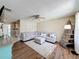 Inviting living room features a comfortable sectional sofa, ottoman, ceiling fan and unique crate shelving unit at 7375 Lake Dr, Sanford, FL 32771
