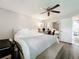 Comfortable main bedroom features a ceiling fan, hardwood floors, and an ensuite bathroom at 7375 Lake Dr, Sanford, FL 32771