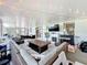 Large sunroom with plenty of seating, a fireplace, string lights, and tile flooring at 7375 Lake Dr, Sanford, FL 32771