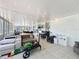 Inviting sunroom with ample seating, string lights, white brick wall, tile floor, and bar for relaxing and entertaining at 7375 Lake Dr, Sanford, FL 32771