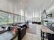 Bright sunroom featuring tile floor, bar, comfortable seating, and walls of windows offering abundant natural light at 7375 Lake Dr, Sanford, FL 32771
