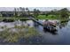 Aerial view of waterfront property with private dock, boat house and mature trees at 7550 John Hancock Dr, Winter Garden, FL 34787
