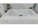 A close up of a soaking tub featuring a control panel and white tiling surround at 7550 John Hancock Dr, Winter Garden, FL 34787