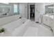 Spacious bathroom featuring a soaking tub, walk-in shower, and large walk-in closet at 7550 John Hancock Dr, Winter Garden, FL 34787