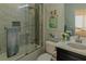 Modern bathroom features shower over tub, decorative tile, and vanity with black cabinets at 7550 John Hancock Dr, Winter Garden, FL 34787