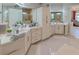Large bathroom featuring double sink vanities, white cabinets, and large mirrors at 7550 John Hancock Dr, Winter Garden, FL 34787