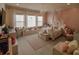 Charming bedroom with large windows, chandelier, reading nook and light colored walls at 7550 John Hancock Dr, Winter Garden, FL 34787