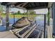 Covered boat lift with black personal watercraft beneath a black cover at 7550 John Hancock Dr, Winter Garden, FL 34787