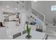 Bright dining area with a view of the gourmet kitchen and modern staircase at 7550 John Hancock Dr, Winter Garden, FL 34787