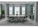 Formal dining room with a modern table, seating for eight, and bright natural lighting at 7550 John Hancock Dr, Winter Garden, FL 34787