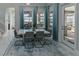 Bright dining room with a modern table, chairs, stylish blue curtains, and beautiful water view at 7550 John Hancock Dr, Winter Garden, FL 34787