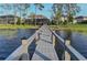 Long dock extending over the lake showing view to other lakefront properties at 7550 John Hancock Dr, Winter Garden, FL 34787