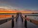 Scenic sunset view of the dock over the water provides a relaxing atmosphere at 7550 John Hancock Dr, Winter Garden, FL 34787
