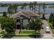 Stunning two-story home with lush landscaping, paver driveway, and beautiful lake view at 7550 John Hancock Dr, Winter Garden, FL 34787