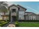 Beautiful home featuring a stone facade, manicured landscaping, and a brick walkway leading to the front door at 7550 John Hancock Dr, Winter Garden, FL 34787