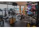 Home gym with water view and high-end work out equipment and black rubber floors at 7550 John Hancock Dr, Winter Garden, FL 34787