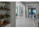 Bright hallway with white tile floors leading to various rooms, showcasing the home's open layout at 7550 John Hancock Dr, Winter Garden, FL 34787