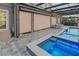 This private jacuzzi area boasts ample lighting, and a screened-in pool, with an extended patio at 7550 John Hancock Dr, Winter Garden, FL 34787