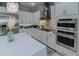 Well-equipped kitchen with stainless steel appliances, white cabinetry, and a center island at 7550 John Hancock Dr, Winter Garden, FL 34787