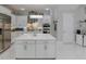 Modern kitchen featuring white cabinets, stainless steel appliances, and a large island at 7550 John Hancock Dr, Winter Garden, FL 34787
