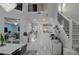 Open-concept living area with a modern kitchen, dining area, and a staircase at 7550 John Hancock Dr, Winter Garden, FL 34787