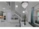 Bright, open living area with soaring ceilings, modern chandelier, and a staircase with black iron railing at 7550 John Hancock Dr, Winter Garden, FL 34787