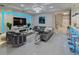 Spacious living area with modern decor, a cozy seating arrangement, and a bar area at 7550 John Hancock Dr, Winter Garden, FL 34787