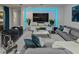 Inviting living room with an entertainment center, comfortable seating, and stylish modern decor at 7550 John Hancock Dr, Winter Garden, FL 34787