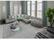 Bright living room with plush gray sofa, stylish pillows, large windows and plenty of natural light at 7550 John Hancock Dr, Winter Garden, FL 34787