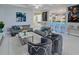 Open-concept living area featuring modern furnishings, stylish lighting, and a bar area at 7550 John Hancock Dr, Winter Garden, FL 34787