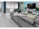 Open living room with a large sectional sofa, modern decor, and patio access at 7550 John Hancock Dr, Winter Garden, FL 34787