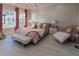 Airy main bedroom with a large bed, chaise lounge, and outdoor views at 7550 John Hancock Dr, Winter Garden, FL 34787