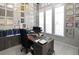 Well-lit office space with custom built-ins, modern desk setup, and neatly displayed awards and certifications at 7550 John Hancock Dr, Winter Garden, FL 34787