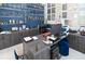 Executive office with a sleek desk, built-in storage, textured blue accent wall and elegant decor at 7550 John Hancock Dr, Winter Garden, FL 34787