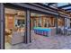 Seamless indoor-outdoor living with a wet bar, grill, and multiple seating areas on the covered patio at 7550 John Hancock Dr, Winter Garden, FL 34787