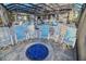 Relaxing screened-in patio features comfortable chairs, a fire pit, and clear views of the pool and backyard at 7550 John Hancock Dr, Winter Garden, FL 34787