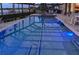 Private screened-in pool with a jacuzzi, lake view, and ample lounge and seating areas at 7550 John Hancock Dr, Winter Garden, FL 34787