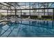 Relaxing screened-in pool with a lake view, extended patio, and plenty of seating at 7550 John Hancock Dr, Winter Garden, FL 34787