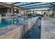 An amazing pool has integrated waterfall features and a screened-in enclosure for year-round enjoyment and low maintenance at 7550 John Hancock Dr, Winter Garden, FL 34787