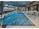 This stunning pool boasts a lake view, an extended patio, dining area, and an outdoor kitchen at 7550 John Hancock Dr, Winter Garden, FL 34787