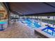 Private screened-in pool with a lake view, extended patio, jacuzzi, and an outdoor kitchen at 7550 John Hancock Dr, Winter Garden, FL 34787