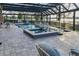 An expansive pool and spa area under a screened enclosure offers luxurious outdoor entertainment and relaxation spaces at 7550 John Hancock Dr, Winter Garden, FL 34787
