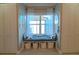 Bright bedroom nook with a window seat, storage baskets, sheer curtains and light walls at 7550 John Hancock Dr, Winter Garden, FL 34787