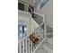 Bright foyer features a staircase with white railings and dark iron balusters at 7550 John Hancock Dr, Winter Garden, FL 34787