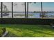 Back yard view of the water with dock, boat house, grass and trees at 7550 John Hancock Dr, Winter Garden, FL 34787