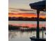 A waterfront view of the property at sunset, showcasing vibrant colors and tranquil scenery at 7550 John Hancock Dr, Winter Garden, FL 34787