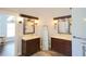 Elegant bathroom with dual vanities, granite countertops, dark wood cabinets, and stylish lighting at 787 High Grove Park Ct, Oviedo, FL 32765
