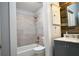Modern bathroom with tub and shower combo, neutral decor, and stylish vanity at 787 High Grove Park Ct, Oviedo, FL 32765