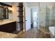 Bright bathroom features a double vanity, shelving, glass door shower and luxury tub at 787 High Grove Park Ct, Oviedo, FL 32765